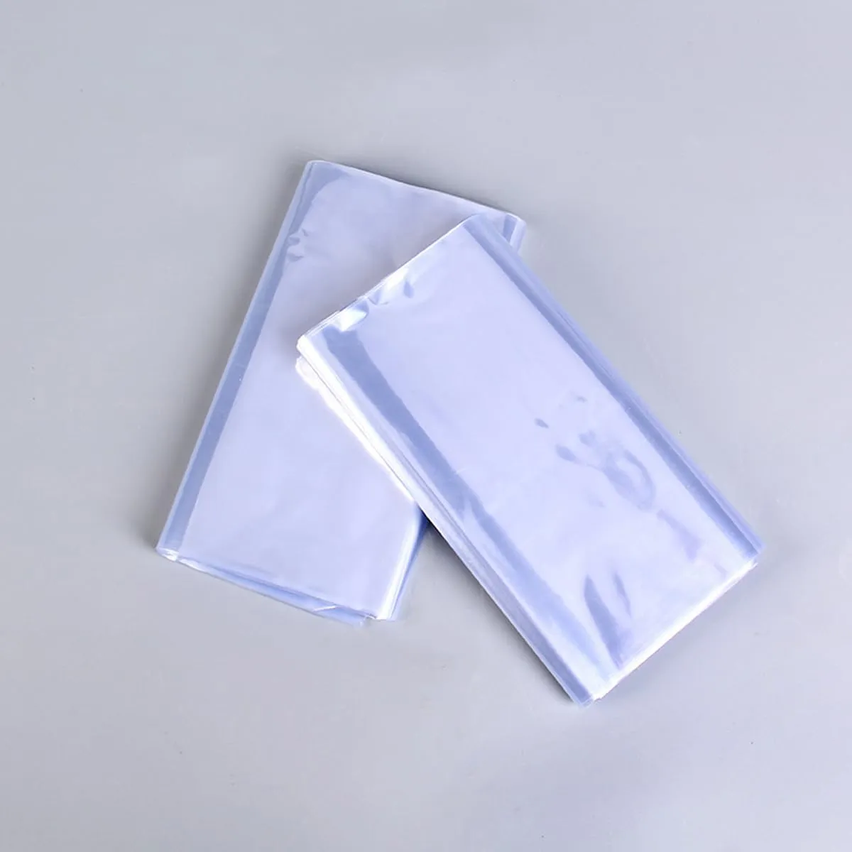Heat Shrink Wrap Bags 100Pcs 15x22 Inches Professional Grade PVC Heat Shrink Wrap is Used to Store Wrap Embellished, Gift Baskets, Shoes, Jars, Industrial Grade Shrink Wrap Bags Transparent